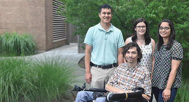 Researchers and patient participant posing outside