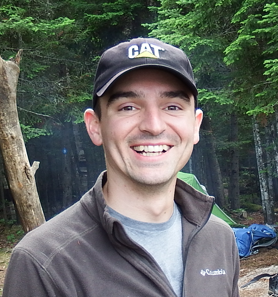 Mitch Kuska smiling with trees behind him 